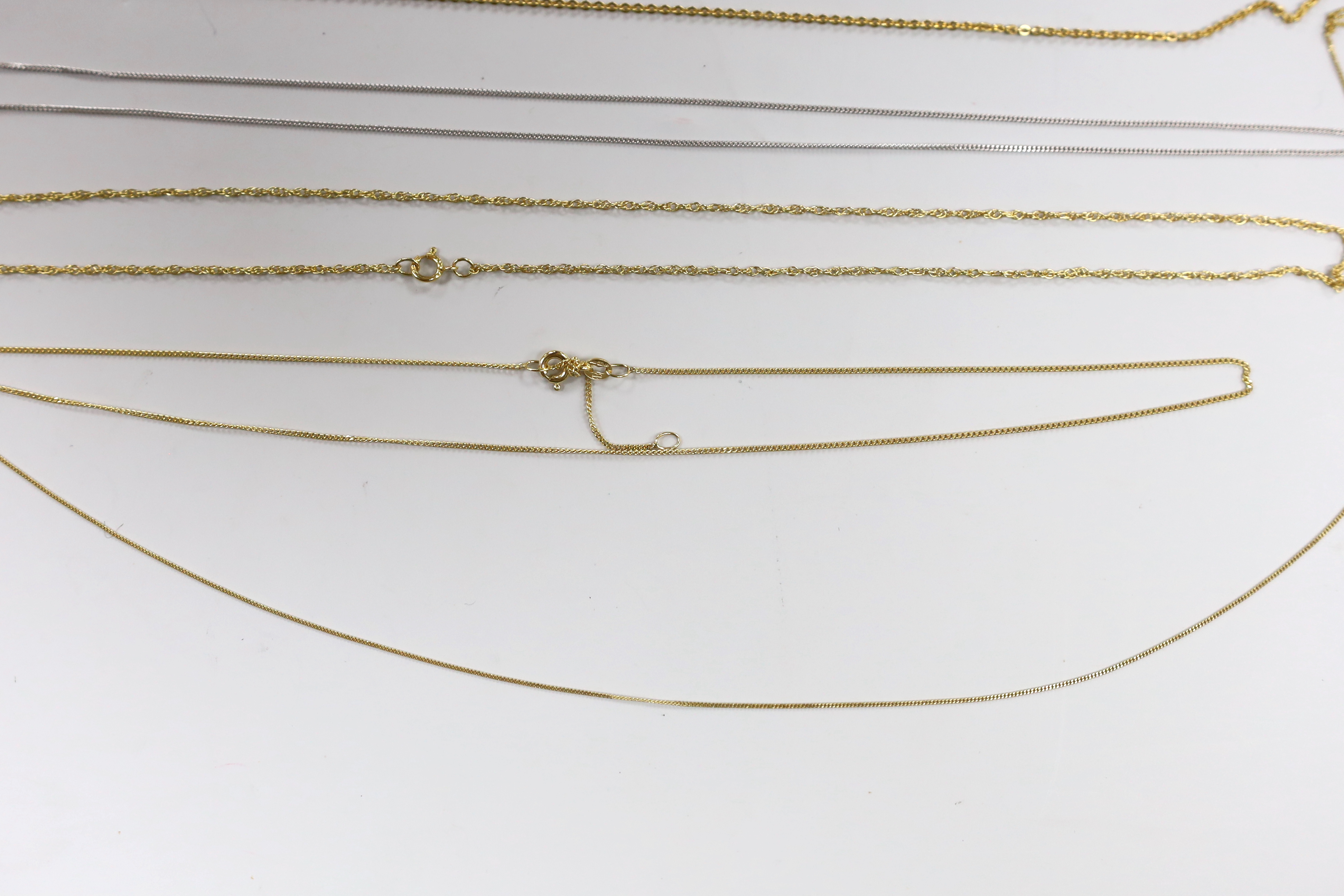 Four assorted modern 9ct chains, longest 44cm, 6.4 grams and one 18ct white gold chain, 44cm, 2.5 grams.